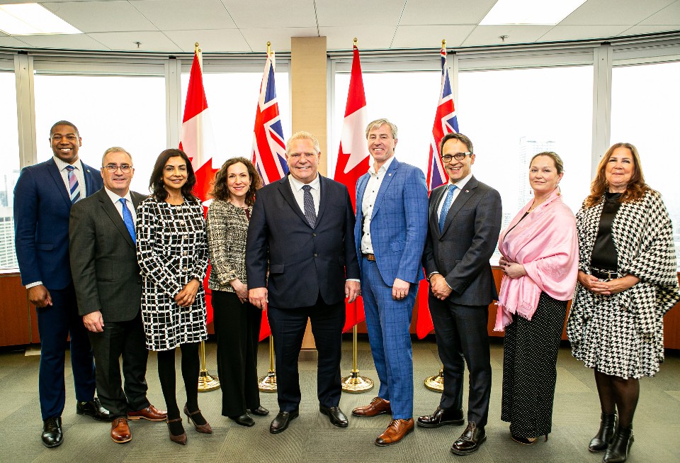 Chamber of commerce chief executives from across Canada standing together in front of Canadian and provincial flags.